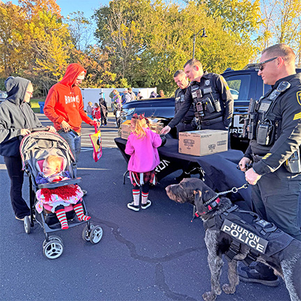 Police officers handing out candy at a trick or treat event